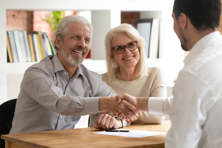 Seniors shaking hands with a staff member