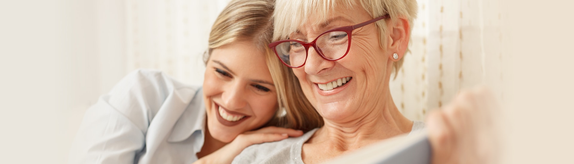 Smiling resident and caregiver sharing a moment.