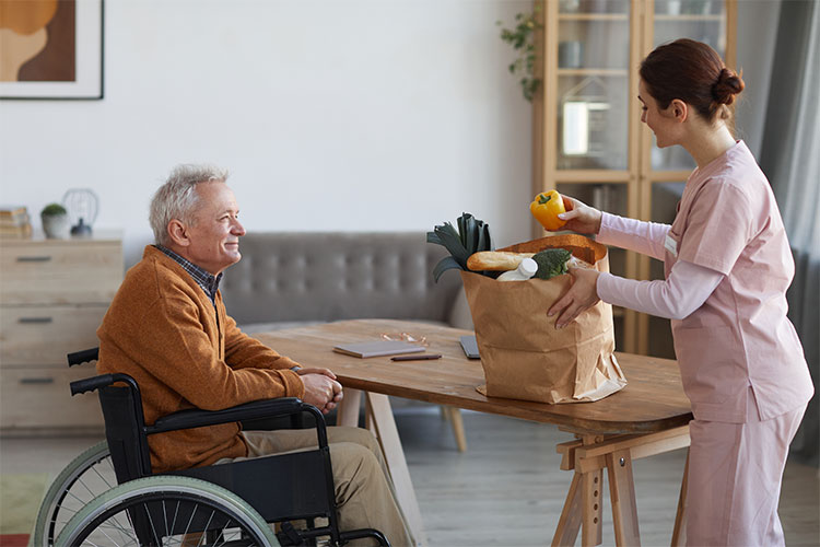 Care staff assisting a resident with groceries