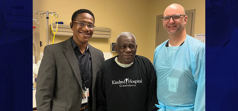 Staff and resident smiling together in facility