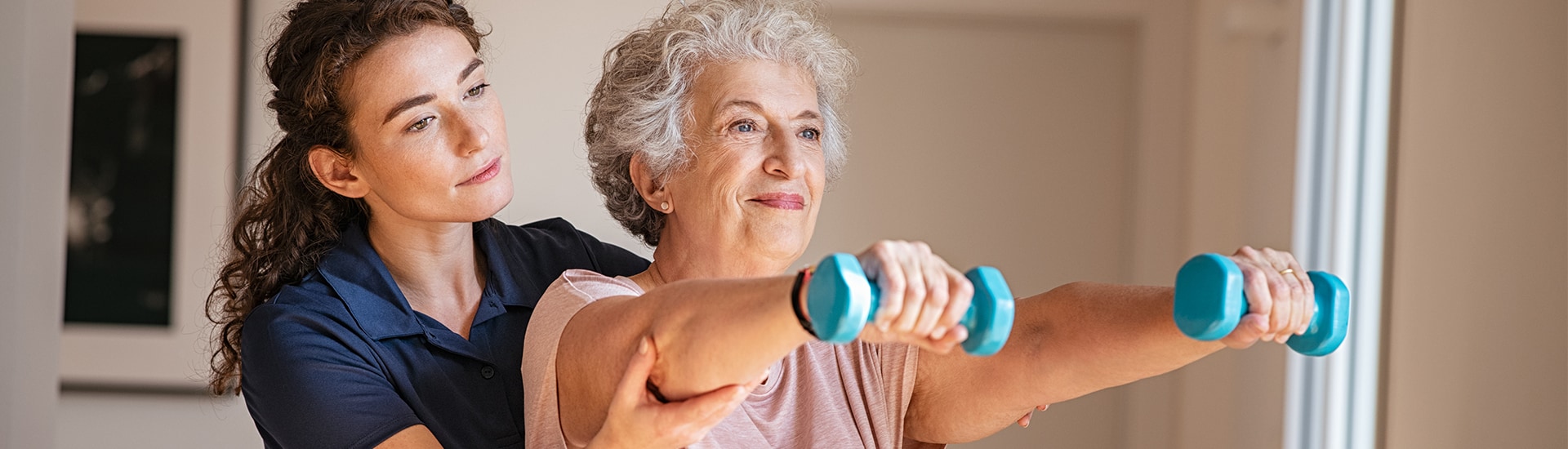 Resident exercising with a staff member's support.