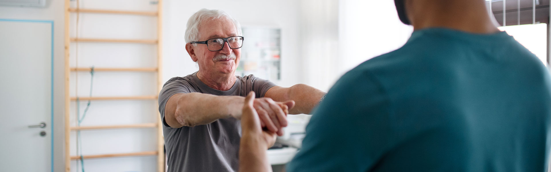 Senior man engaging in a therapy session with a caregiver.