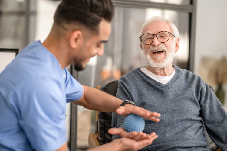 Caregiver interacting with elderly resident in a friendly manner.