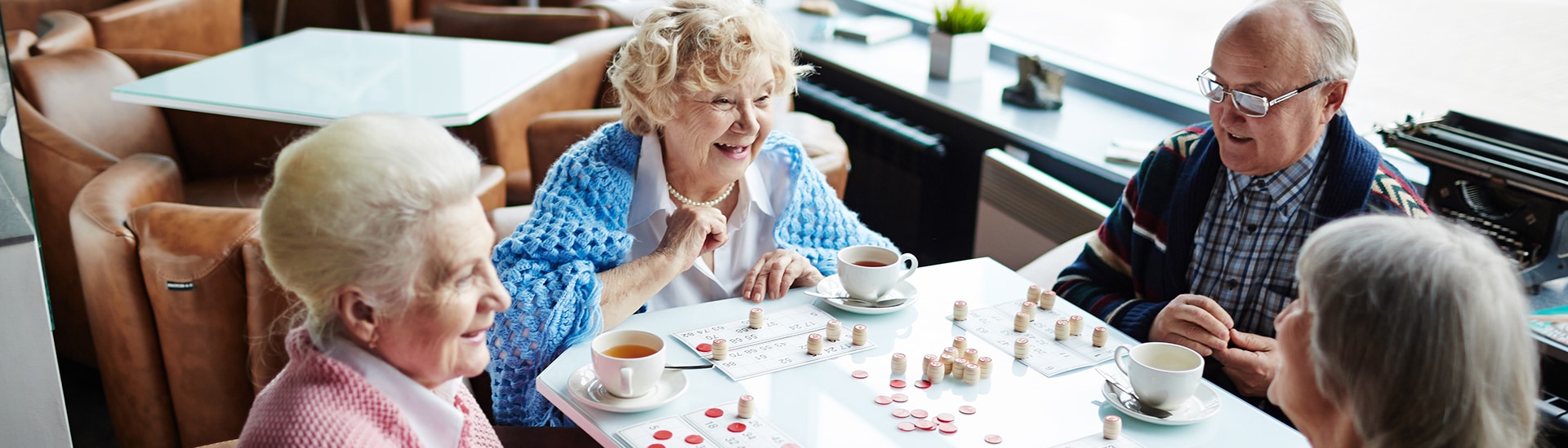 Residents enjoy games and tea in a common area.