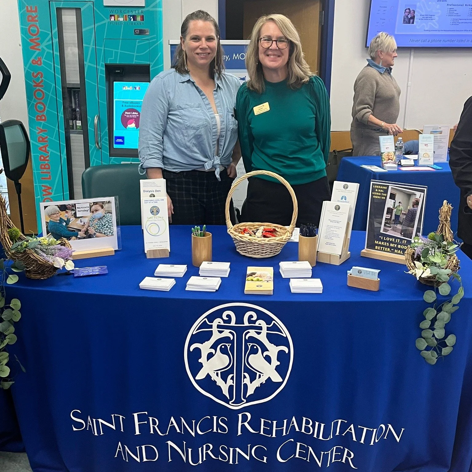 Staff members at a table with informational materials.