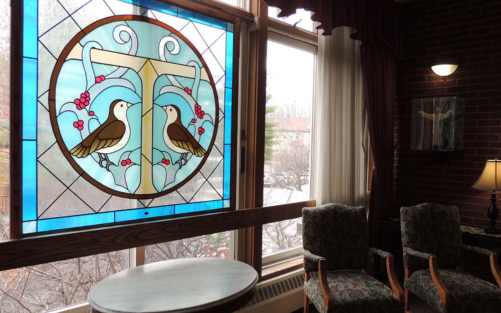 Stained glass window with birds and floral design