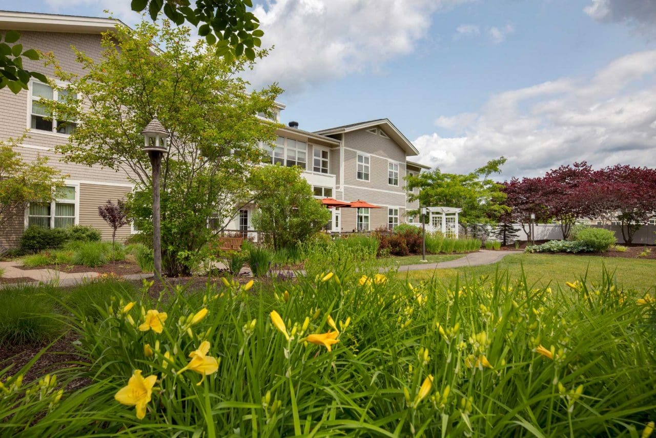 Exterior view of the assisted living facility with flowers
