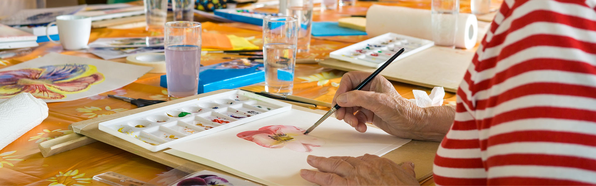 A resident painting in a creative arts class.