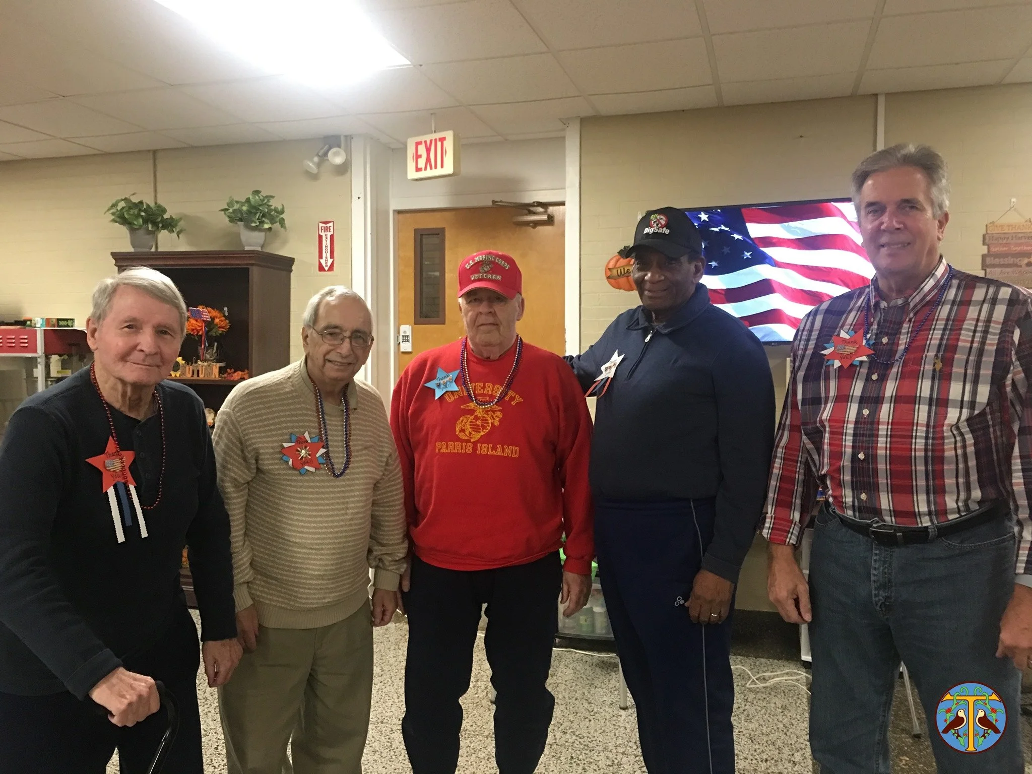 Residents and staff celebrate an event together indoors.
