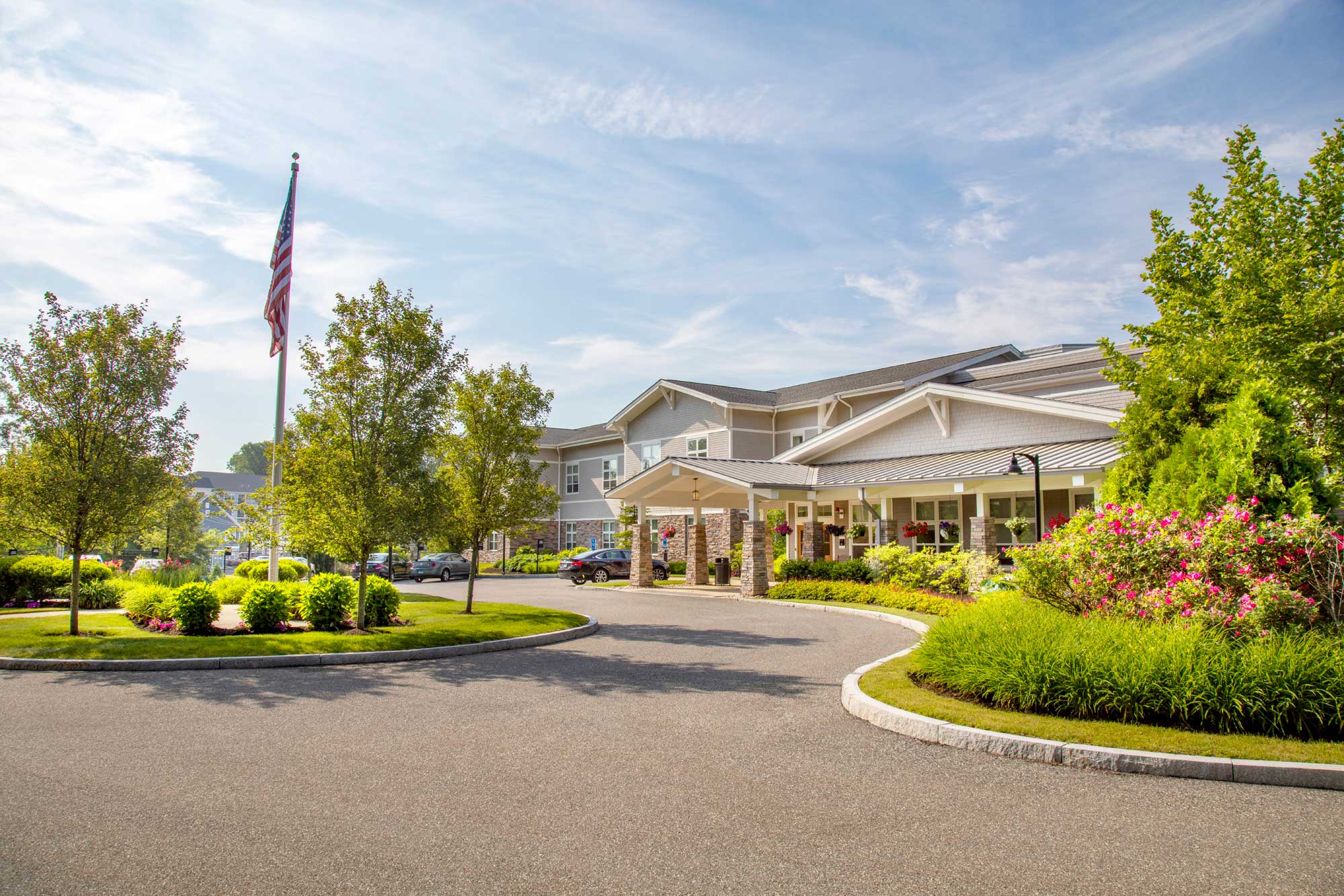 Facility entrance with landscaping and American flag