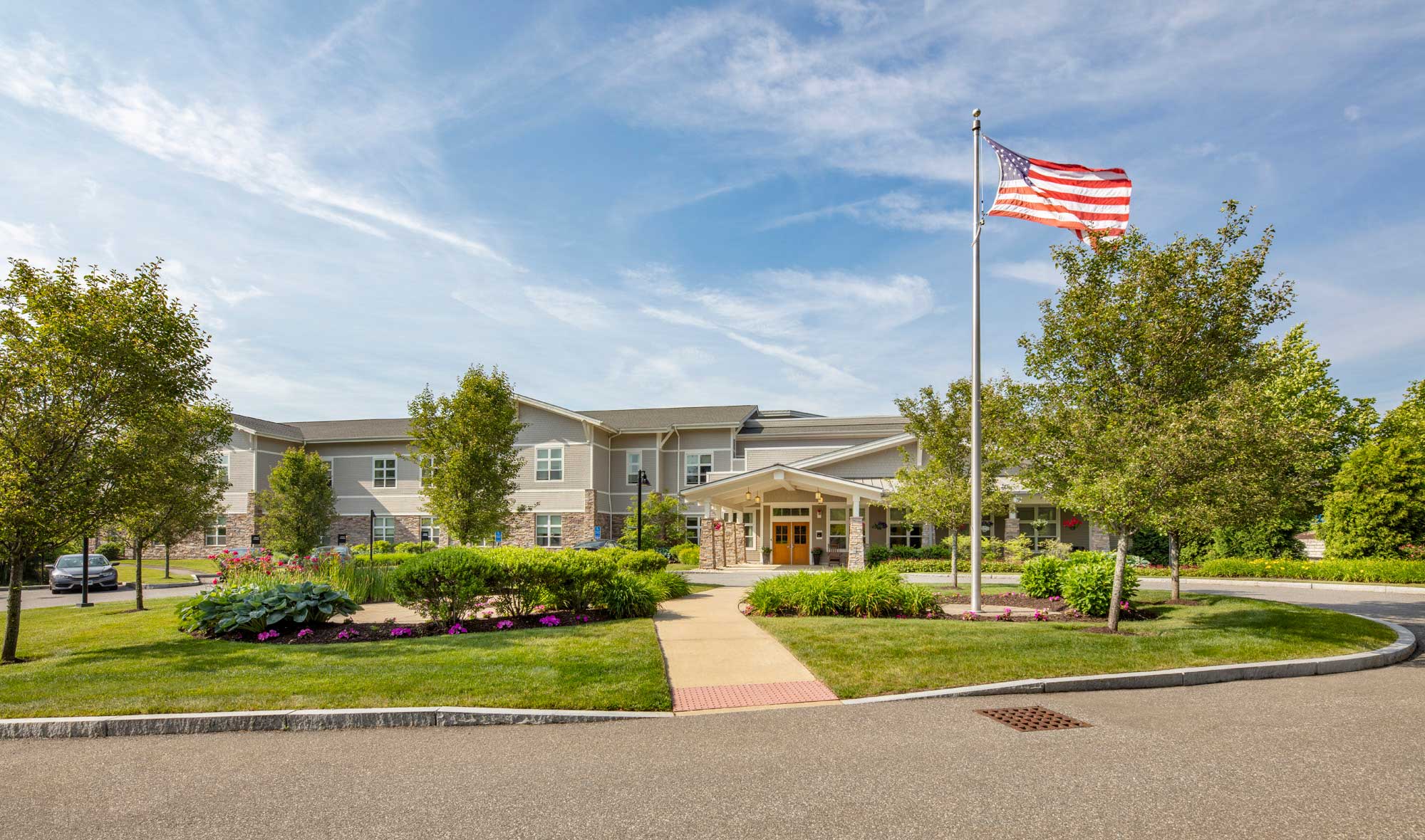Exterior view of assisted living facility with flag.