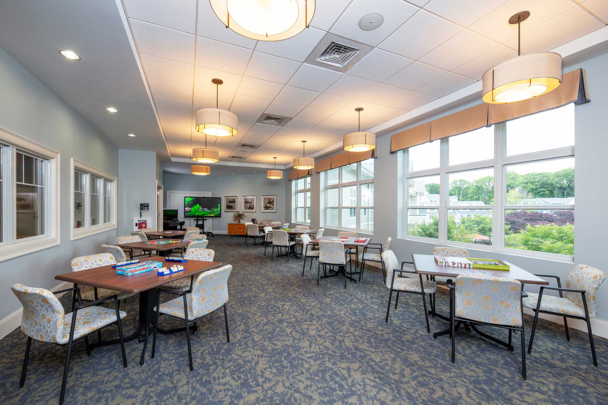 Spacious common area with tables and chairs.