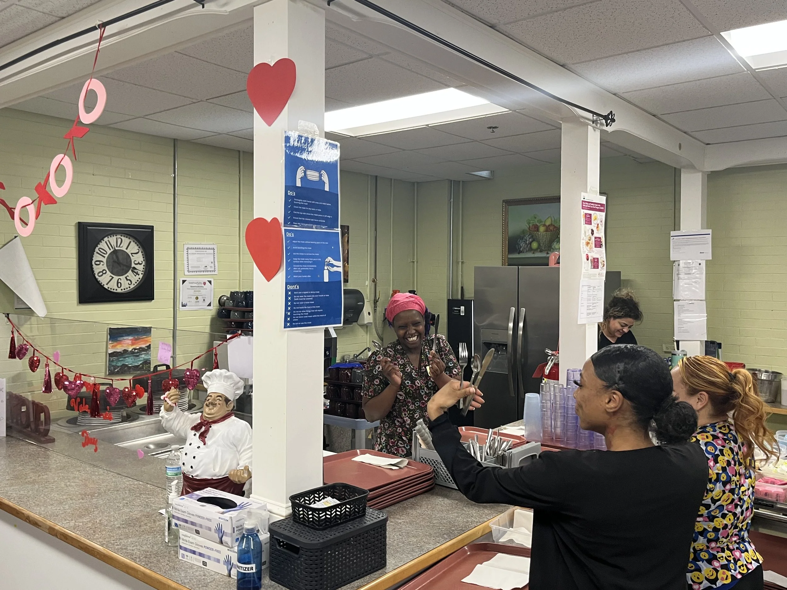 Staff interacting and celebrating in the kitchen