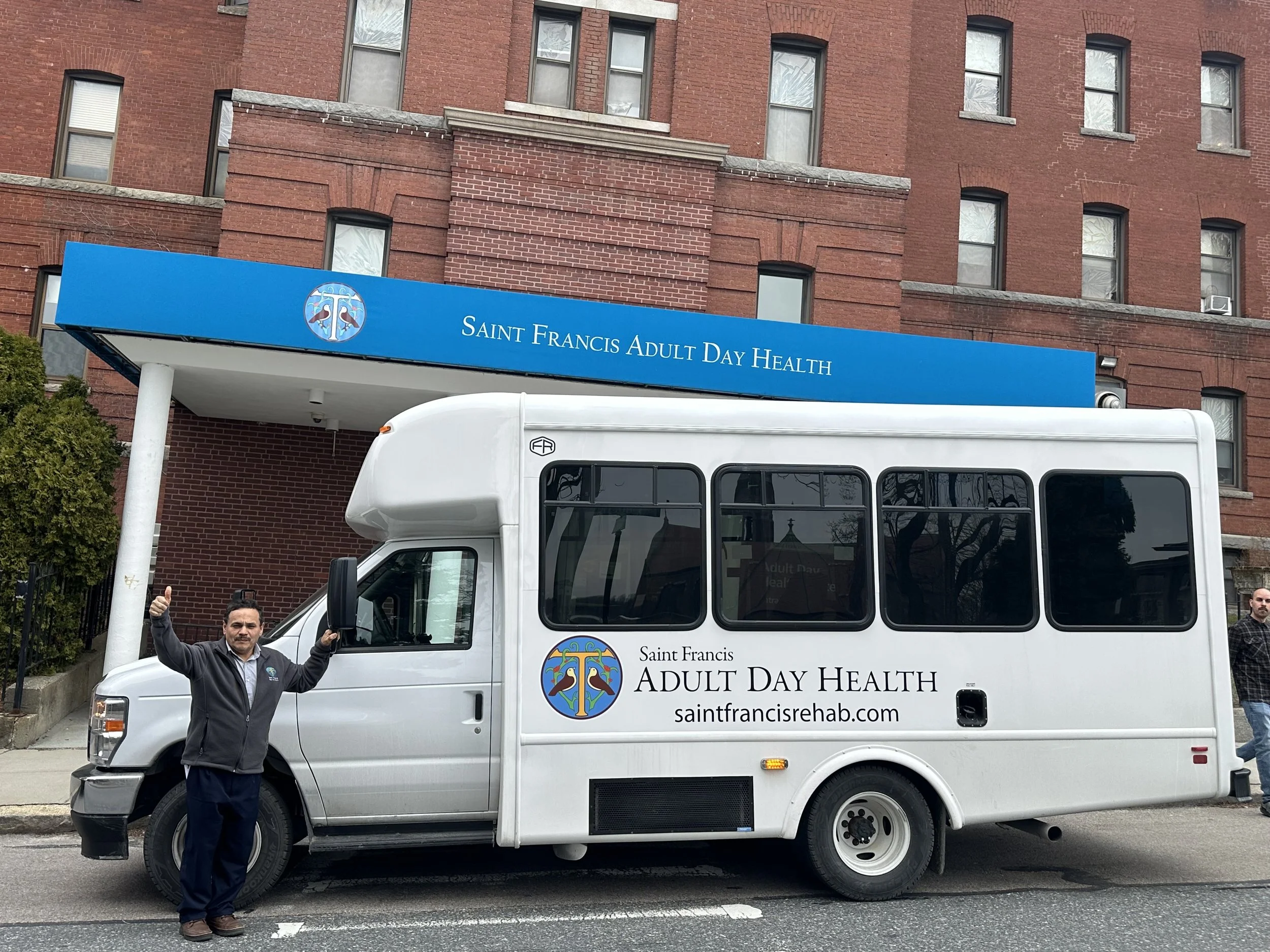 Facility transport van parked outside the building.
