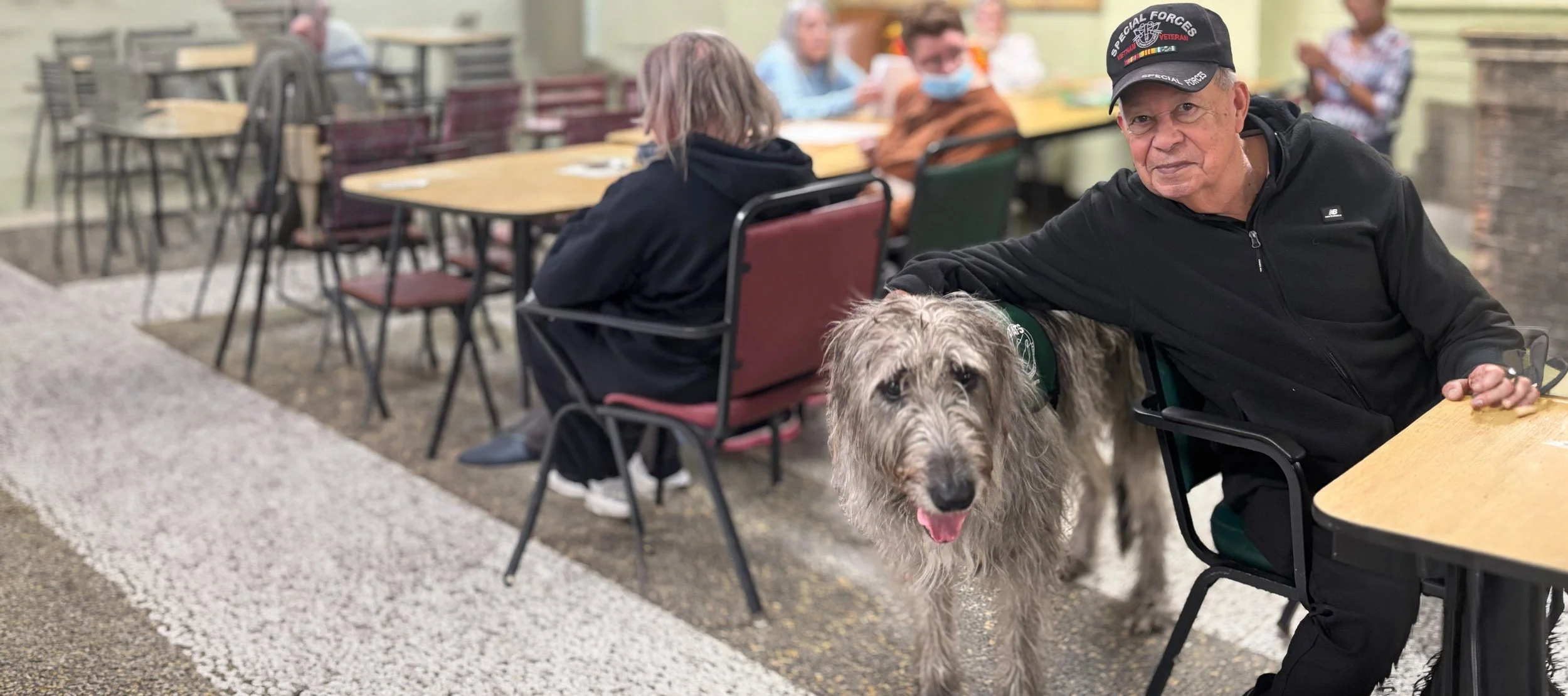 Resident interacting with a dog in a common area.