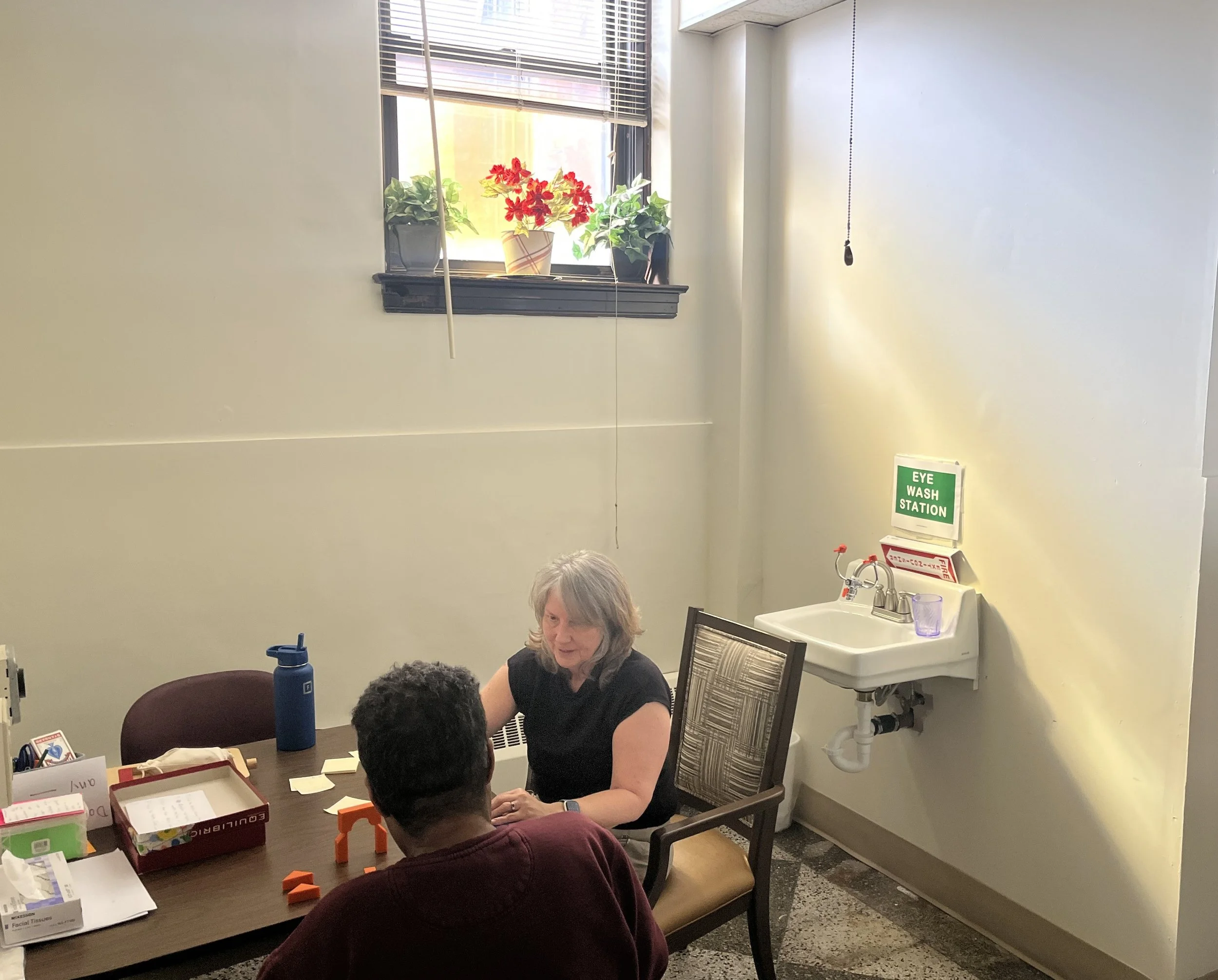 Residents engaged in a social activity at a table.
