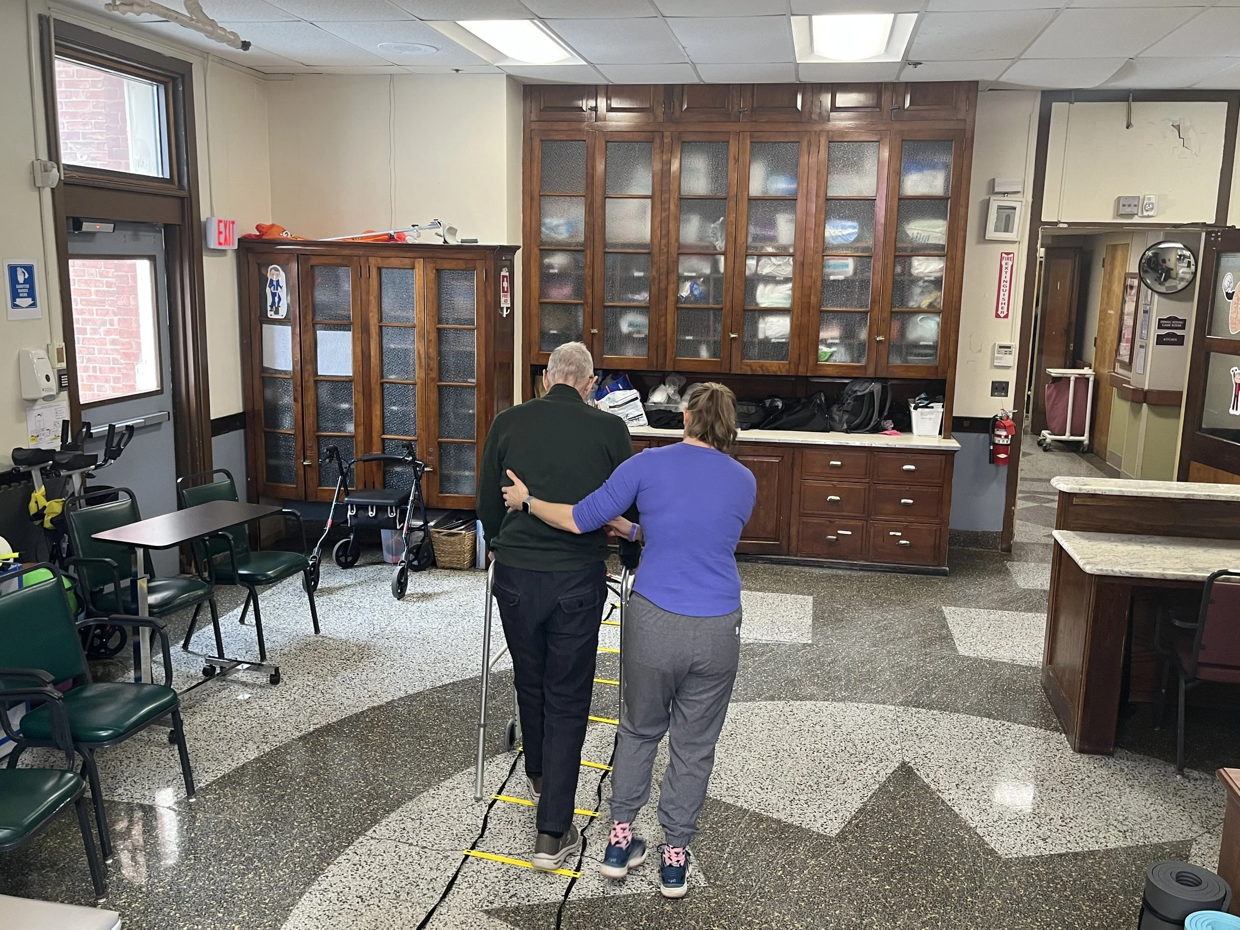 Staff assisting a resident in an interior space