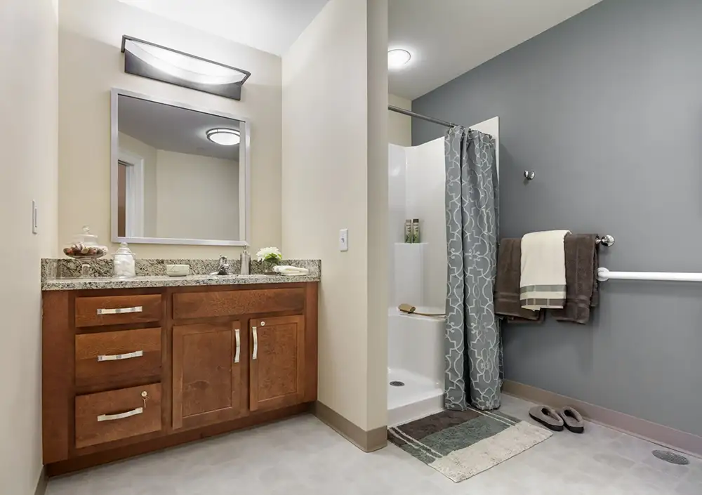 Modern bathroom with shower and amenities.