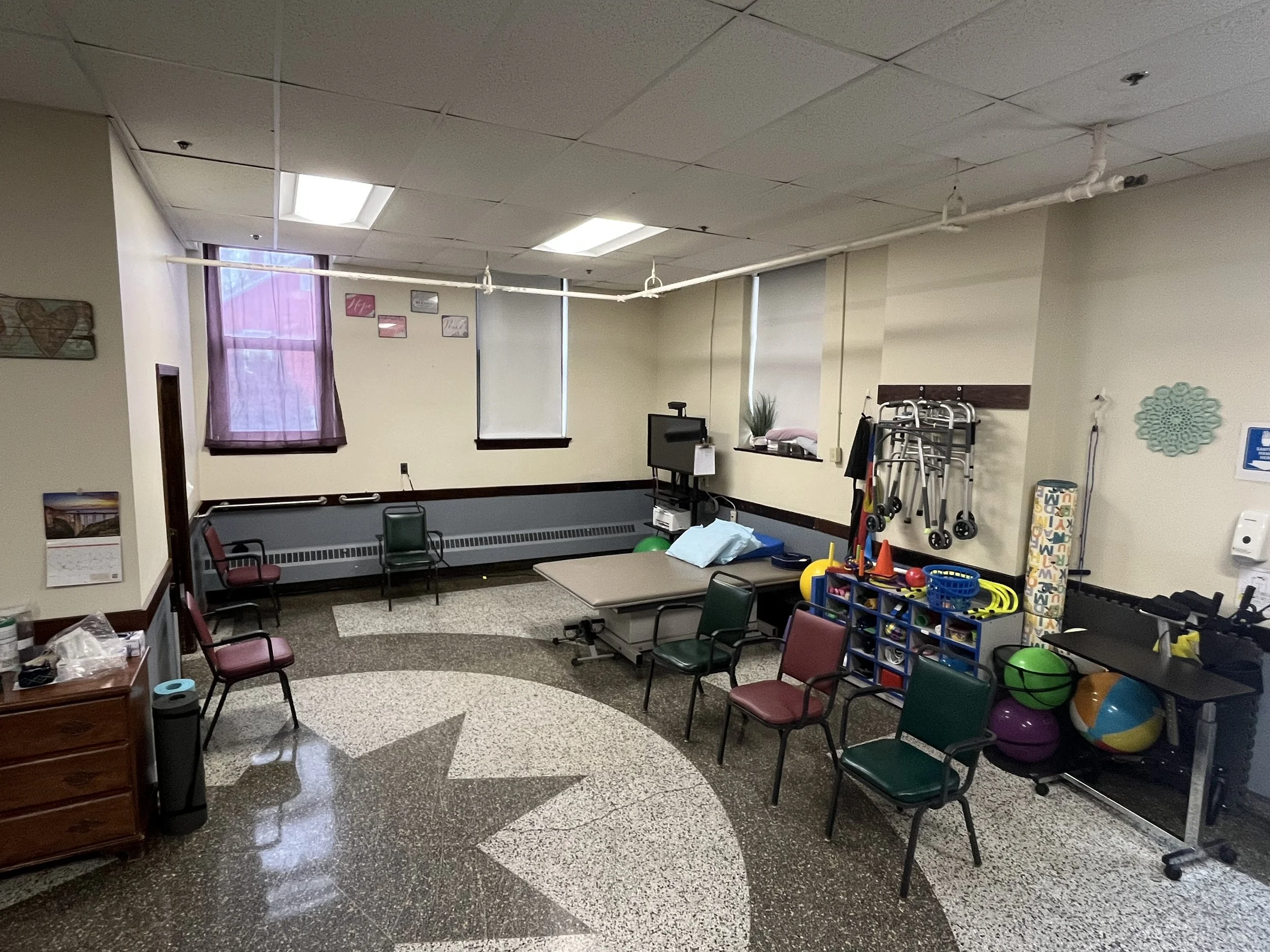 Therapy room with exercise equipment and chairs