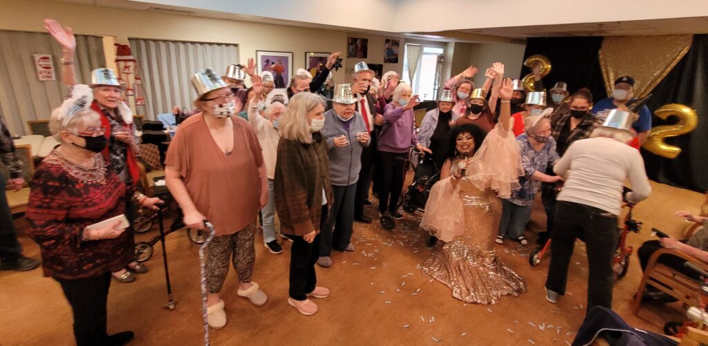 Residents celebrating with a performer during an event.