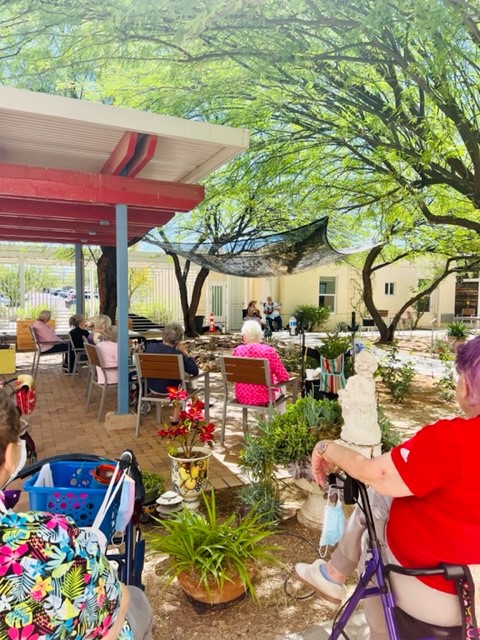 Residents enjoying an outdoor activity in a garden area.