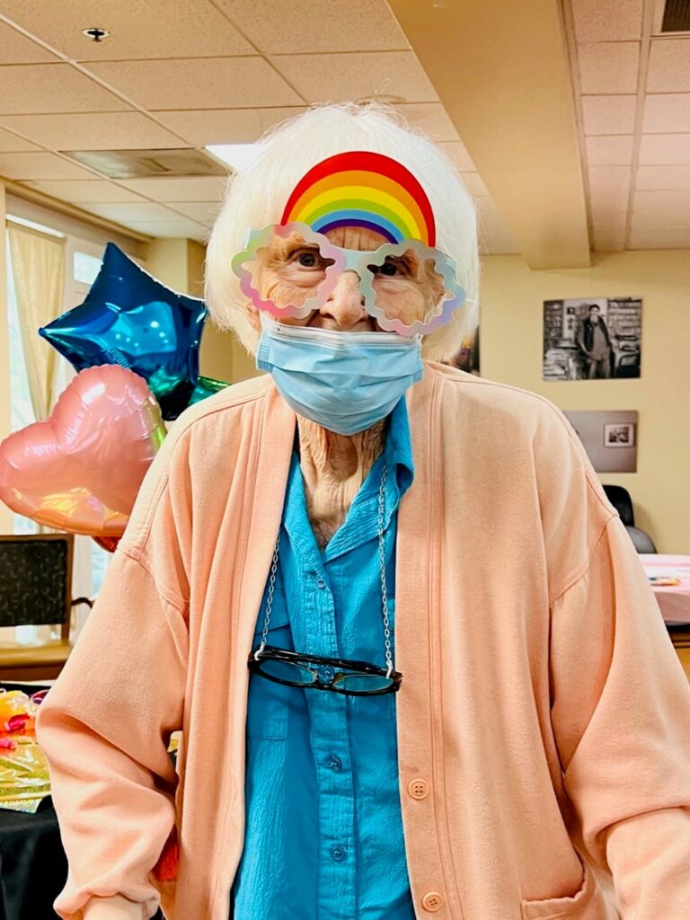 Resident wearing festive glasses at a celebration.