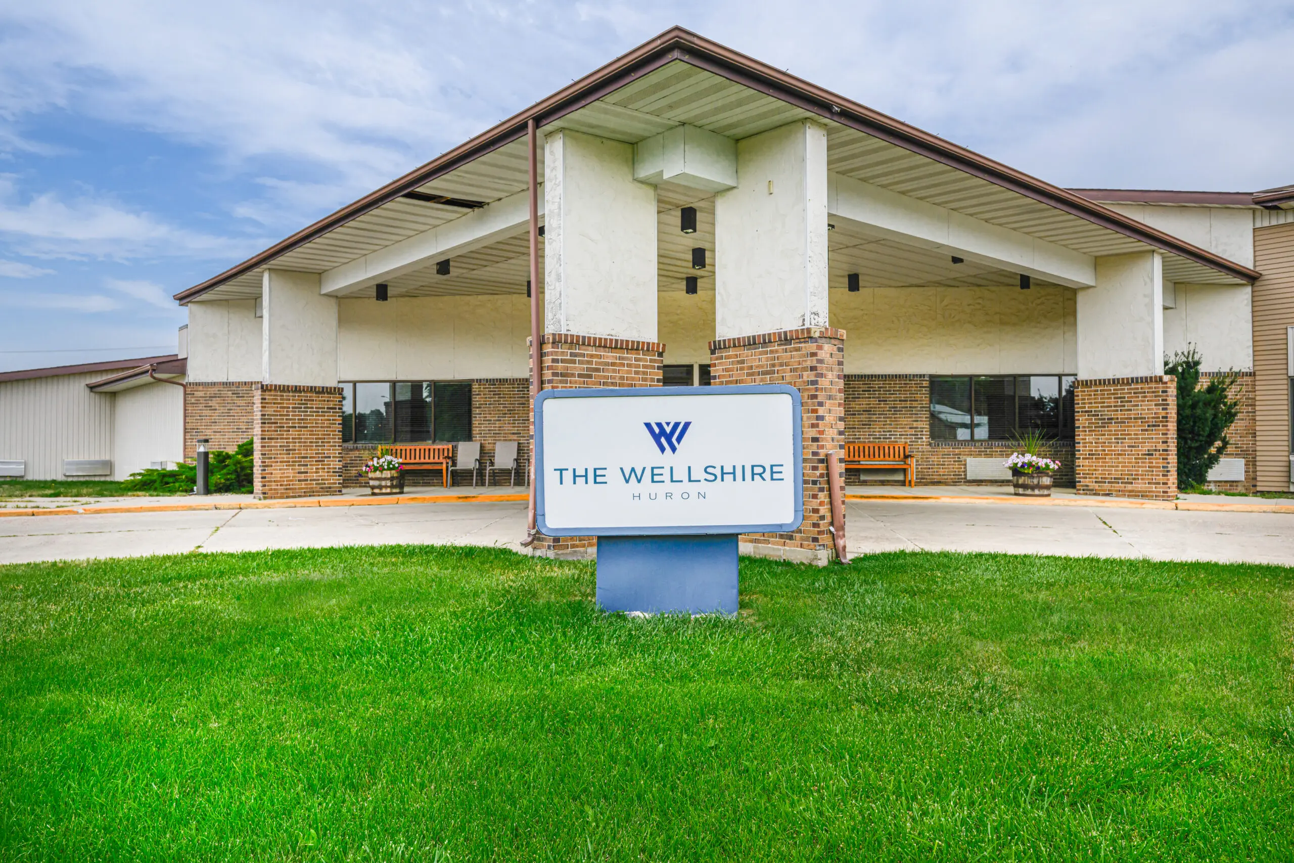 Exterior view of The Wellshire Park Place building entrance.