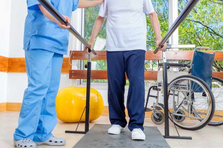 Staff assisting a resident in rehabilitation