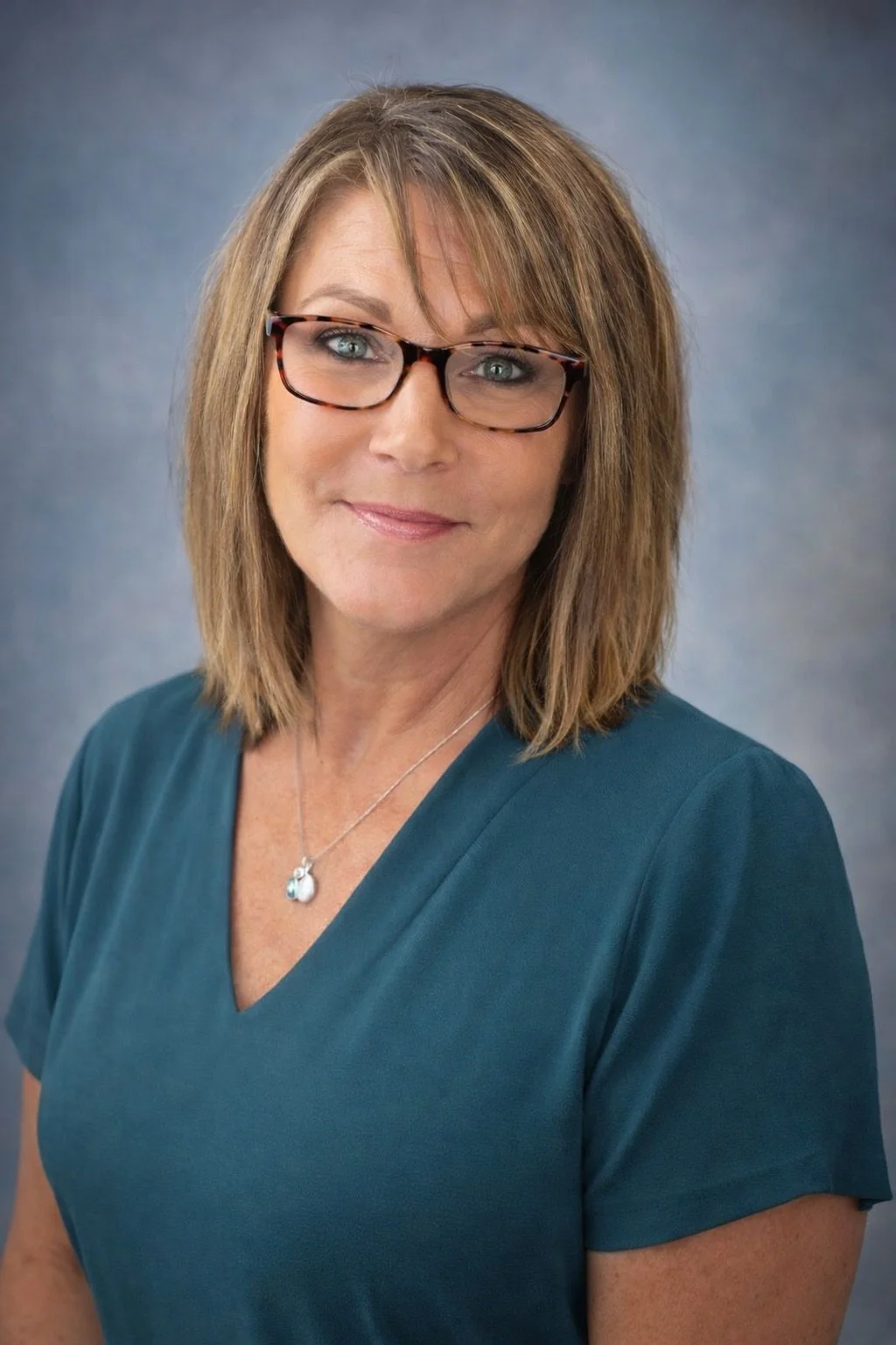 A staff member smiling in professional attire