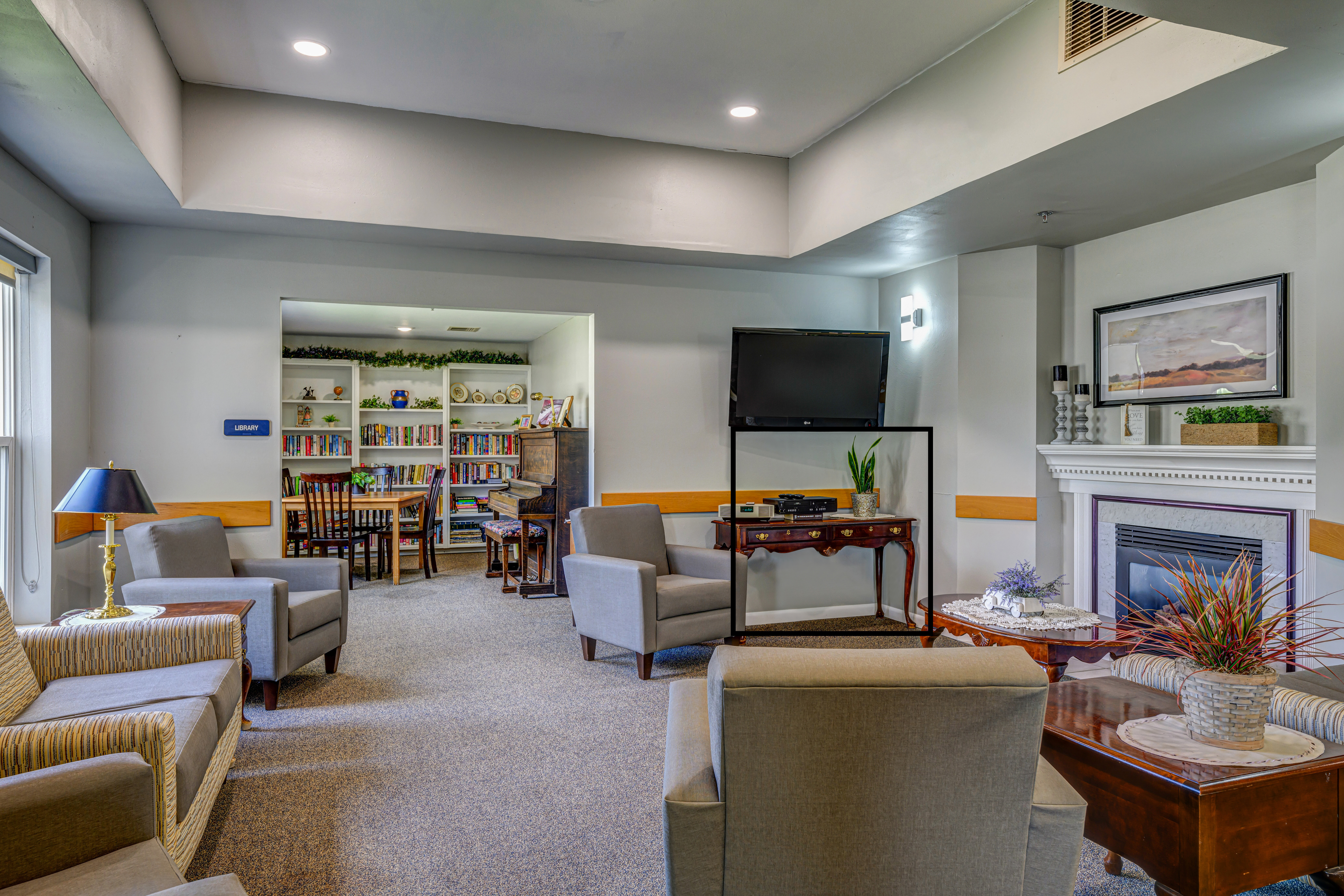 Cozy common area with seating and bookshelves.
