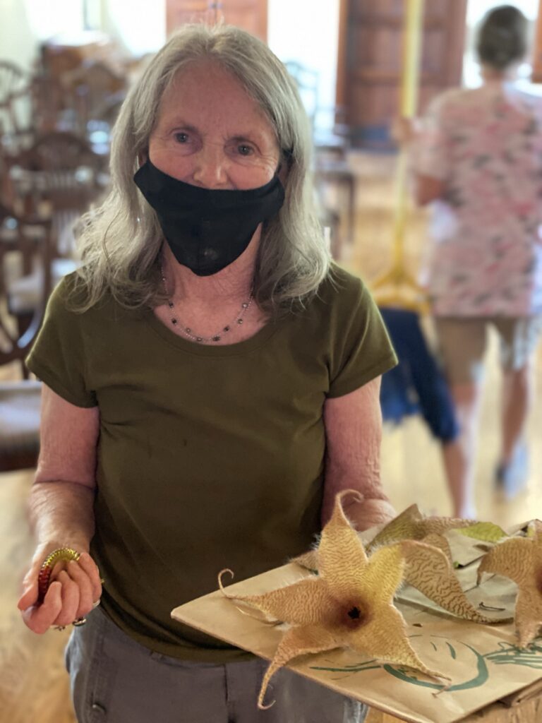 Resident holding a display of starfish in a common area.