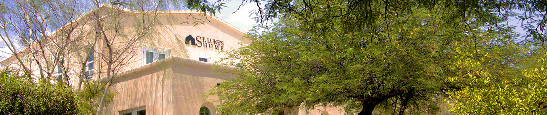 Exterior view of Saint Luke's Home with trees