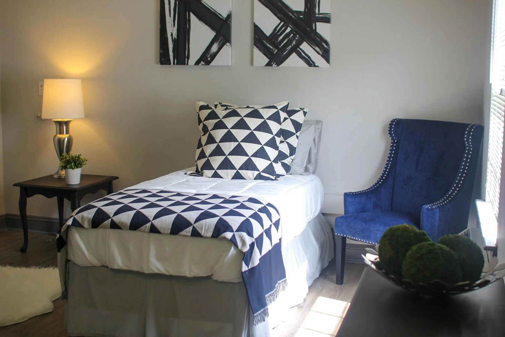 Cozy resident room with a bed and armchair