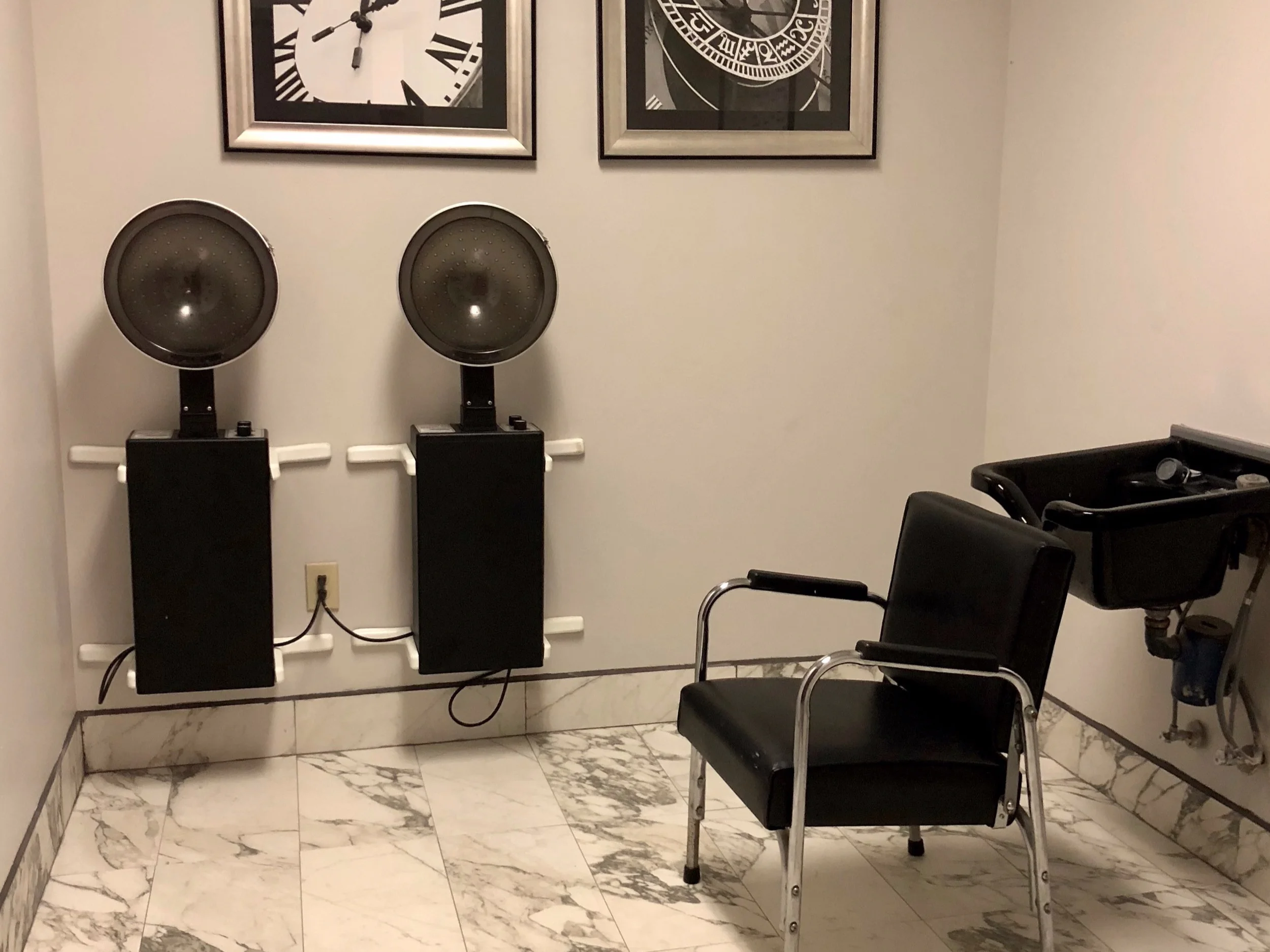 Hair salon area with styling equipment.
