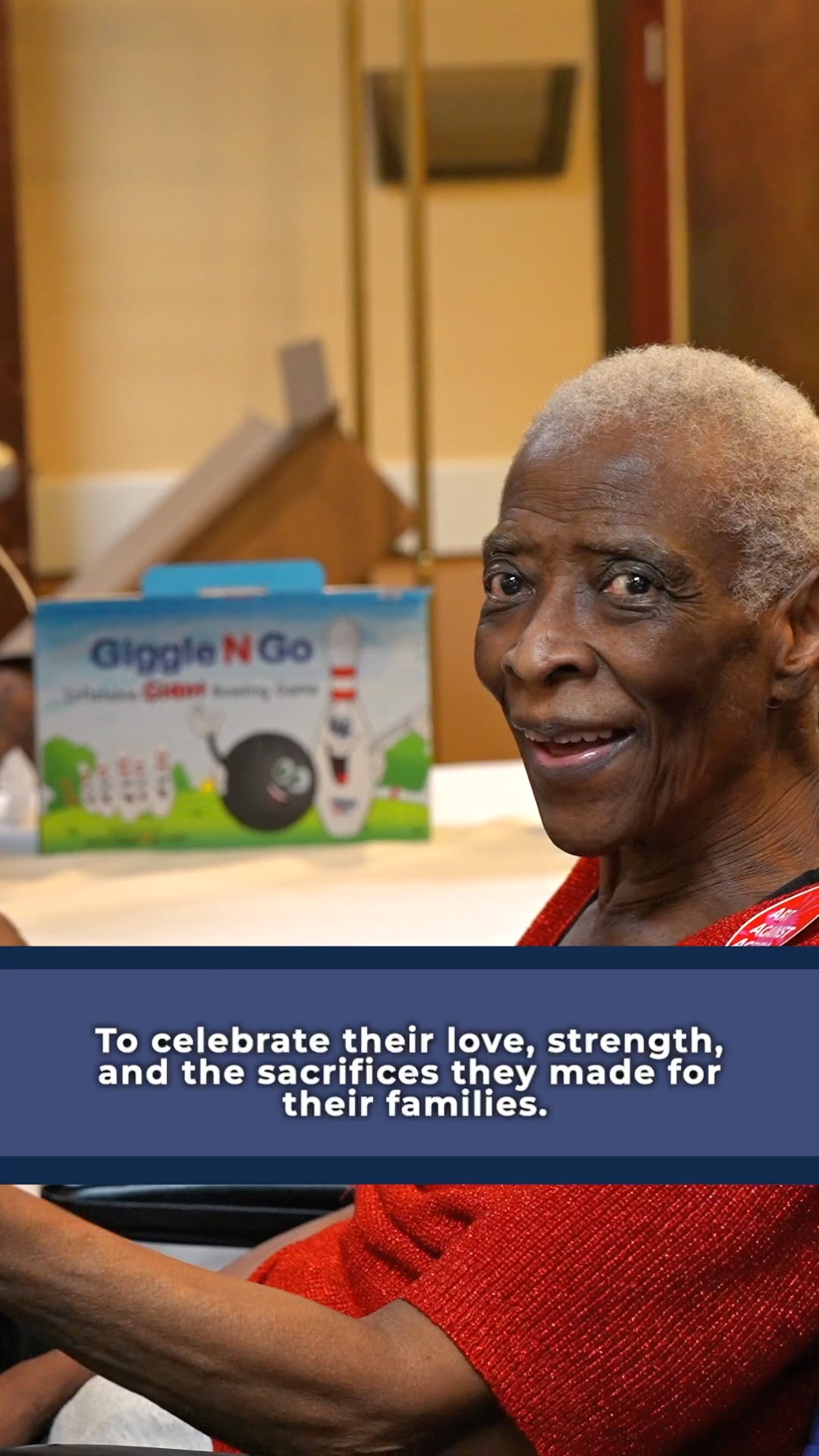 Resident smiling in a common area during activity.