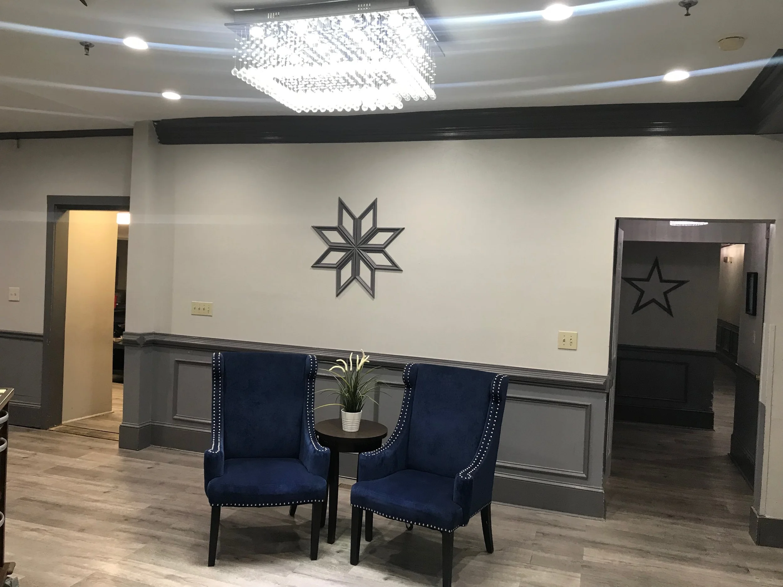 Interior seating area with blue chairs and chandelier