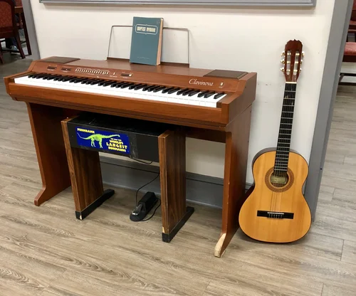 A piano and guitar in a common area.