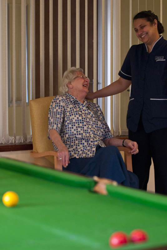 Resident sharing a joyful moment with staff member