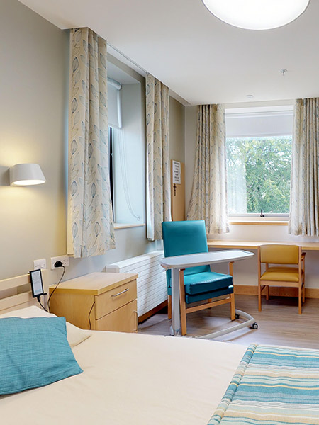 Cozy resident room with a bed and seating area