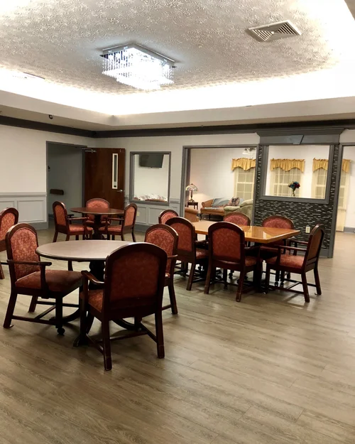 Dining area with tables and chairs set up for residents.