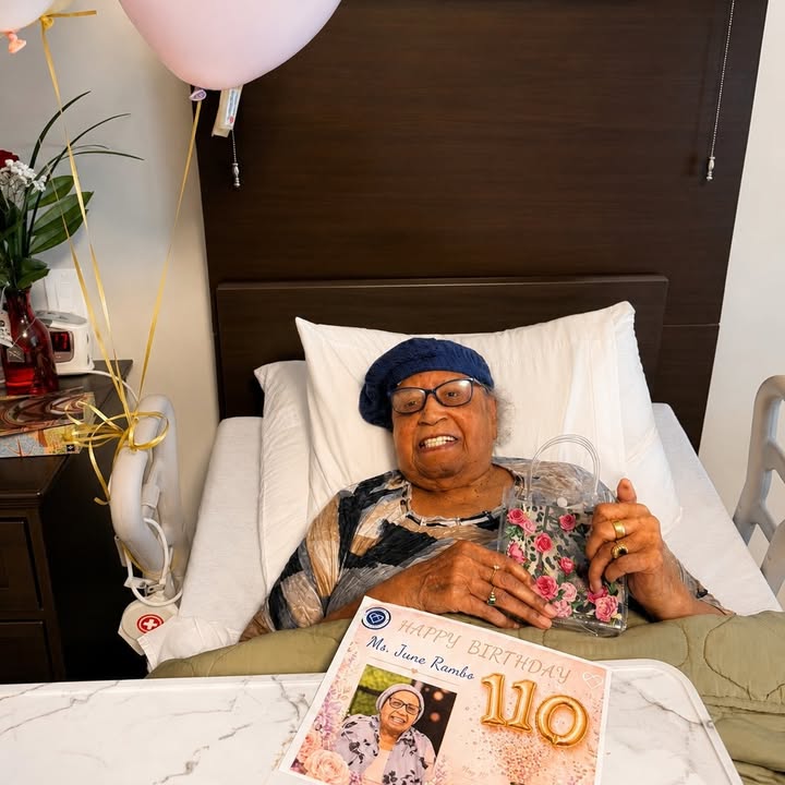 Resident celebrating her 110th birthday with balloons.