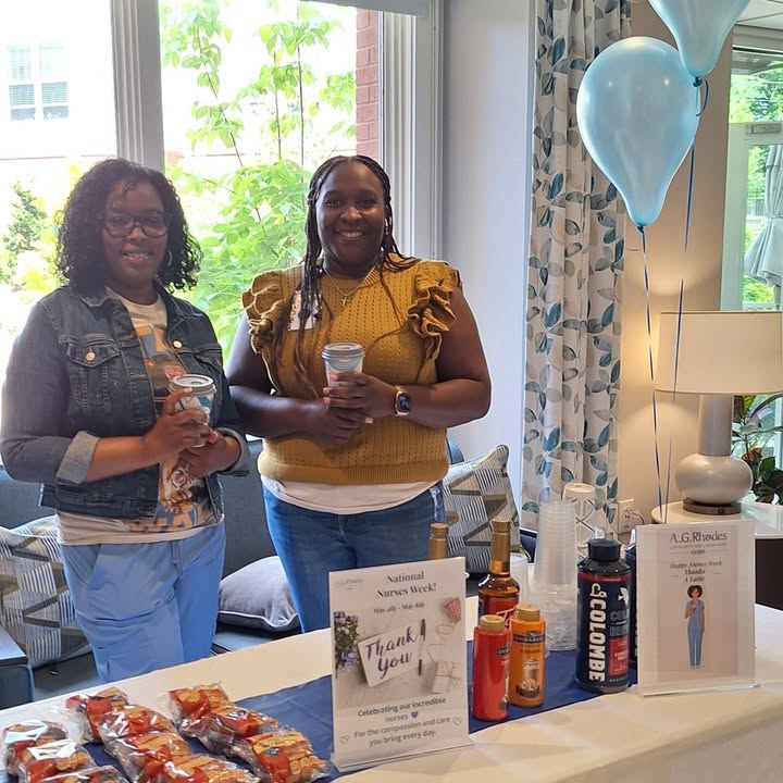 Staff members smiling at a celebration table.