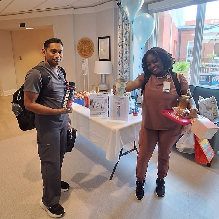 Staff members celebrating an event with decorations.