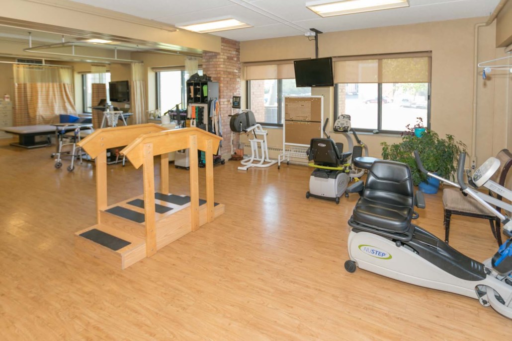 Therapy room with exercise equipment and aids.