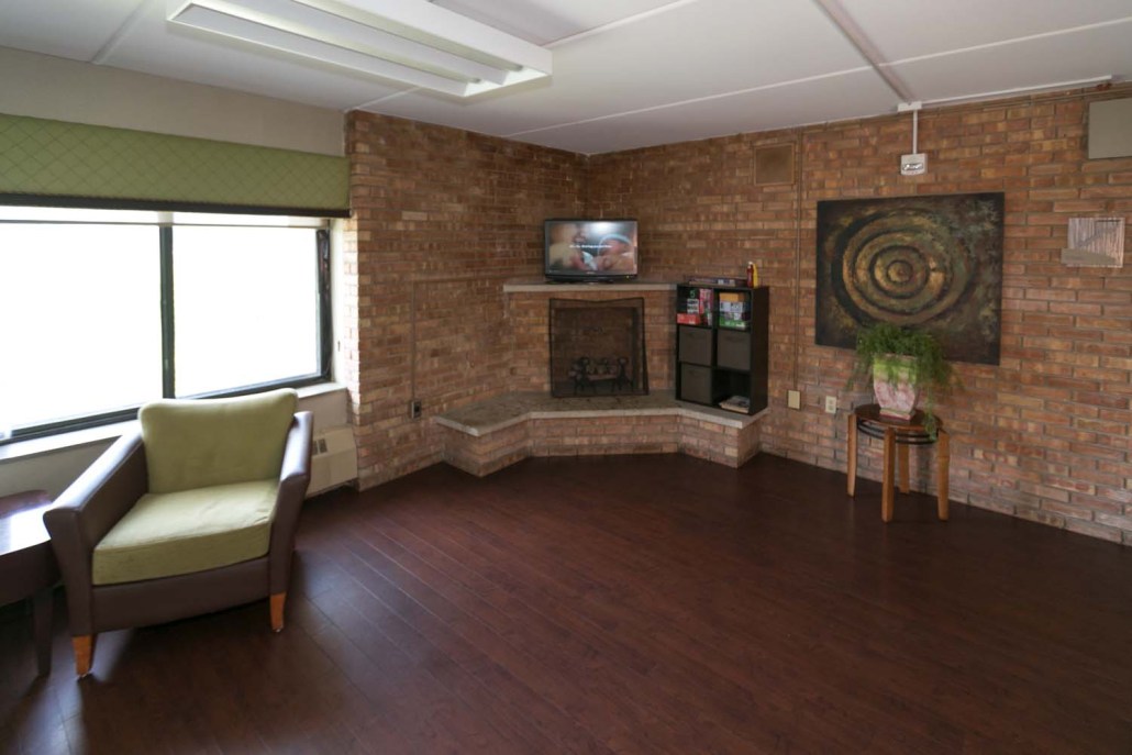 Cozy common area with seating and a TV.