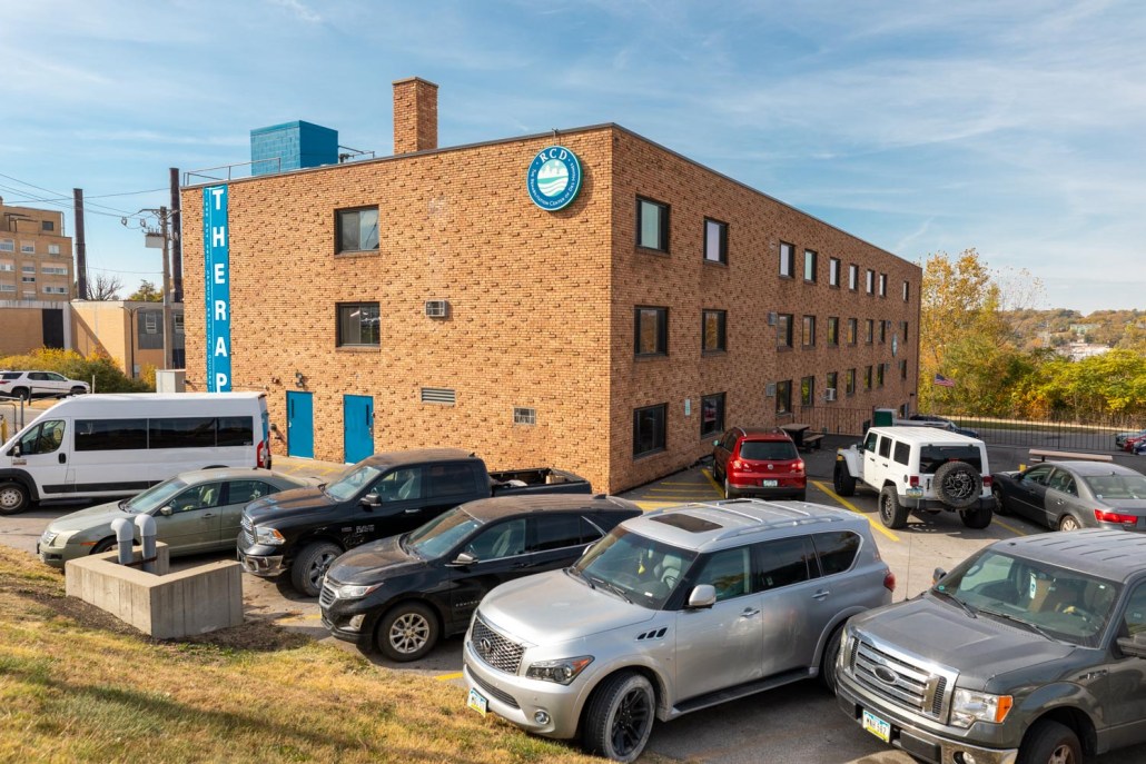 Exterior view of the rehabilitation center with vehicles