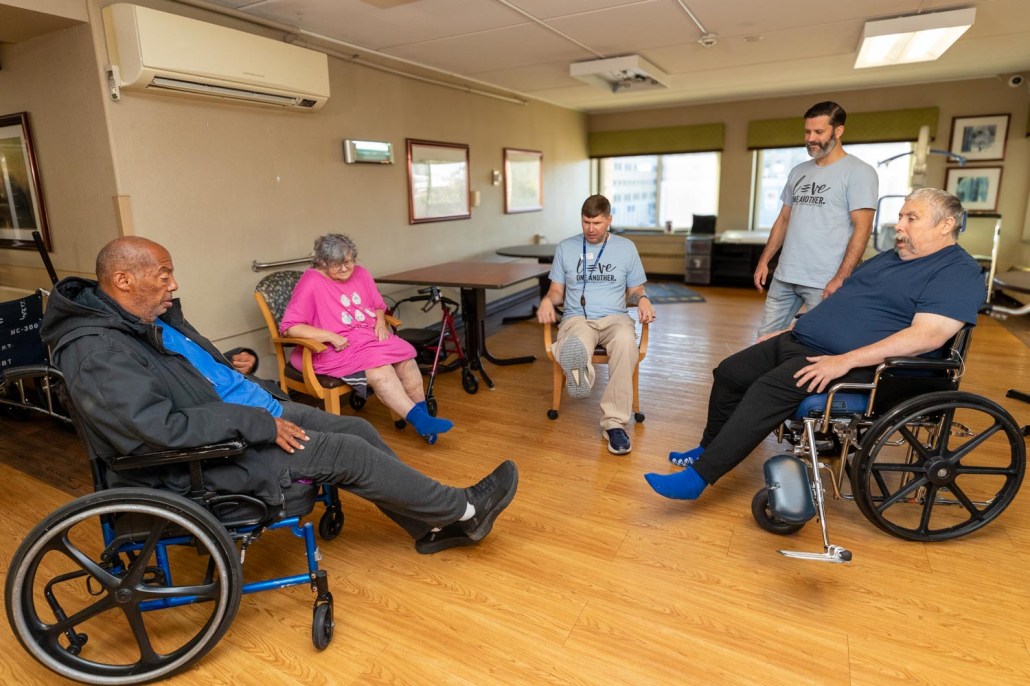 Residents and staff engaged in an exercise activity.