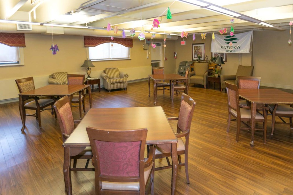Common area with tables and chairs, decorated ceiling.