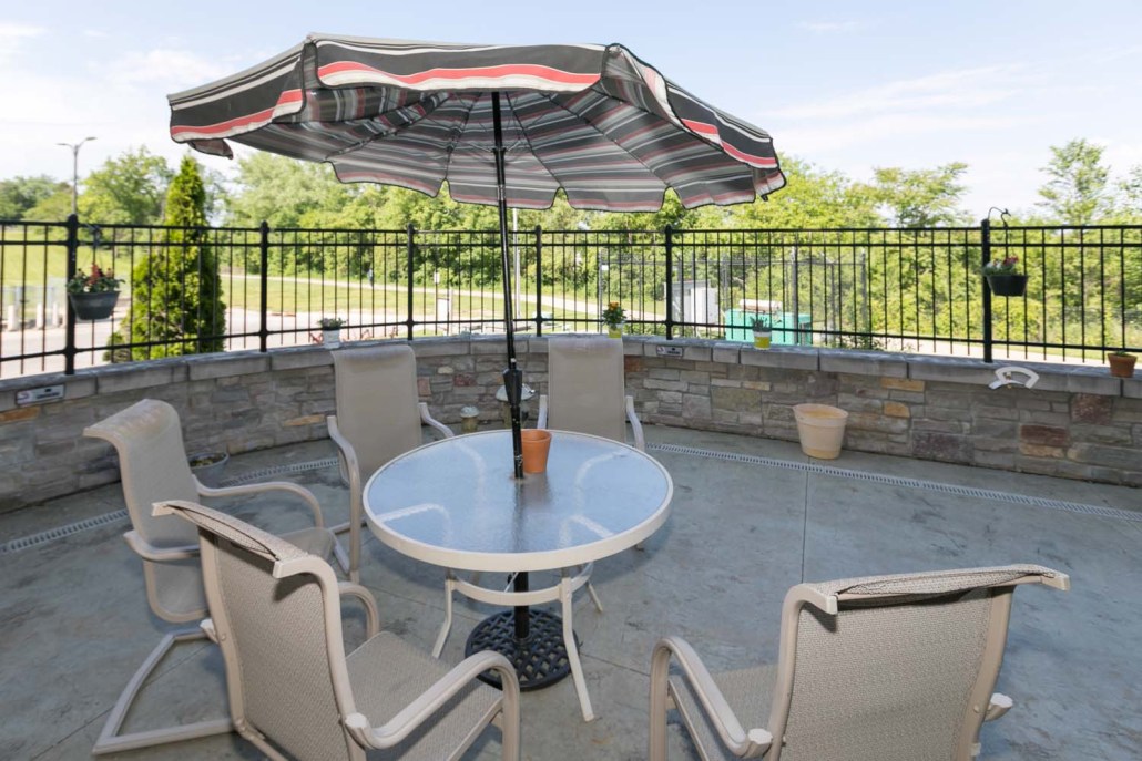 Outdoor seating area with umbrella and chairs.