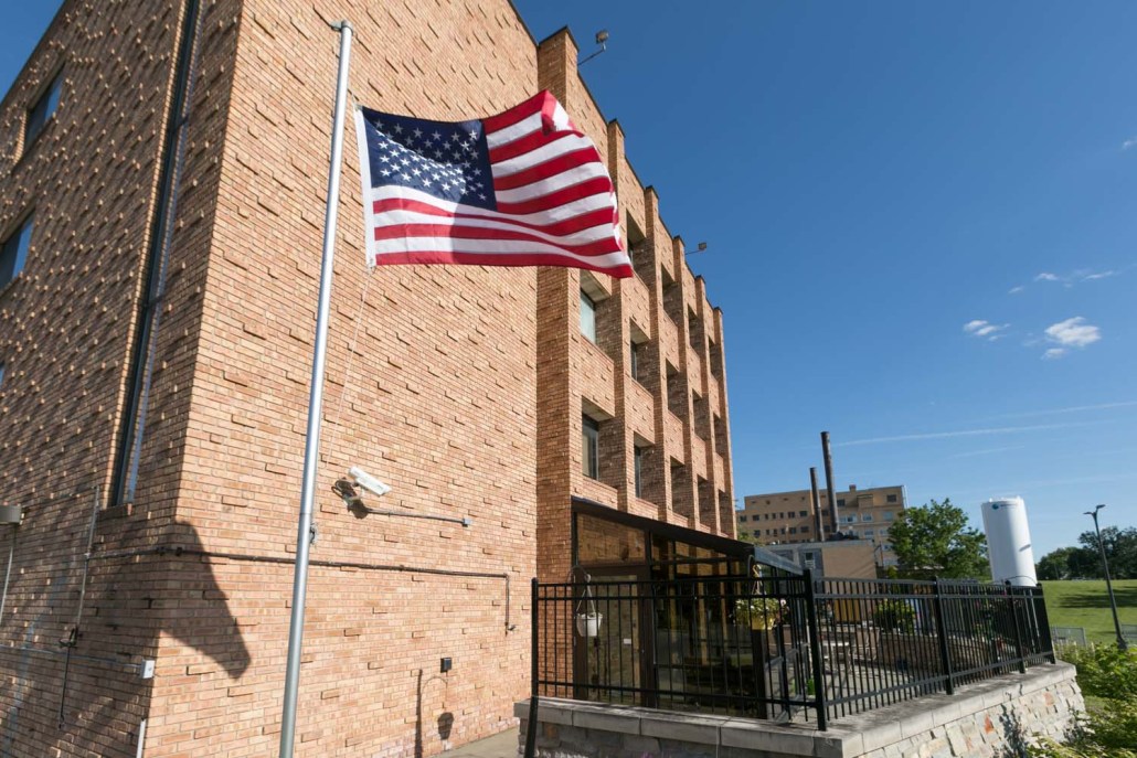 Exterior view of the facility with a flag.